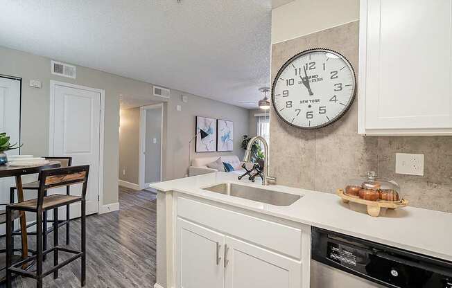 A kitchen with a clock on the wall at Sterling Point Apartment Homes, Phoenix, 85042