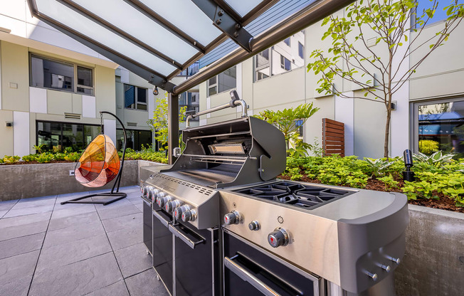 a stainless steel outdoor kitchen with a grill