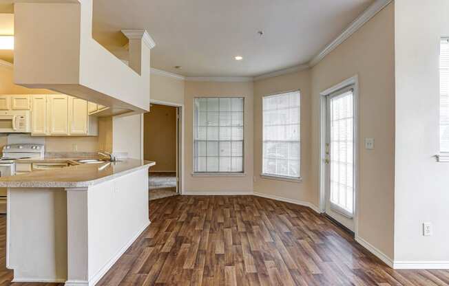 Spacious kitchens and dining rooms with wood floors at Turnberry Isle Apartments in Dallas, TX.