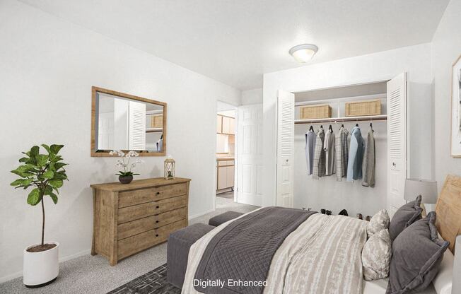 A bedroom with a bed, dresser, mirror and a closet at Hampton Lakes Apartments, Michigan, 49534