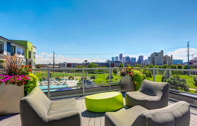 Outdoor community lounge deck with comfortable seating looking out onto stunning views of Downtown Denver.