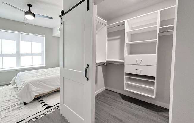 California-style walk-in closet and bedroom in model