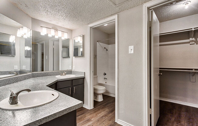 a bathroom with a sink and a mirror at The Broadwater at Salado Creek, San Antonio, TX, 78216