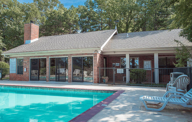 a swimming pool in front of the club house with a pool