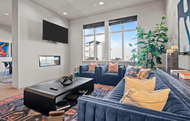 a living room with blue couches and a tv