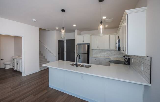 a kitchen with white cabinets and a white counter top at The Crossings at Windsong, Prescott Valley, Arizona
