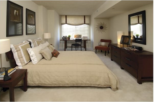 a bedroom with a large bed and a desk