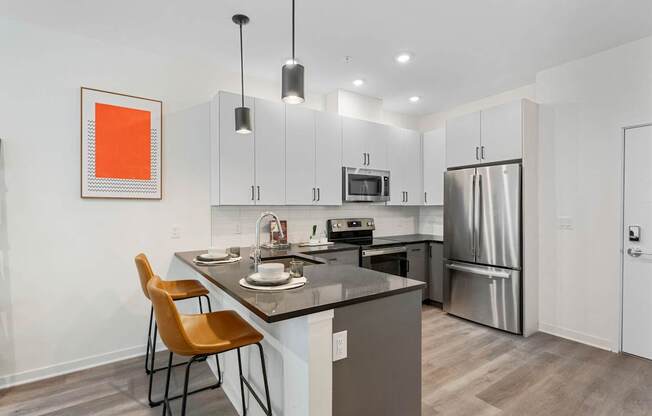 A kitchen with a table and chairs and a fridge.at 829 Garfield, Jersey City, NJ 07305