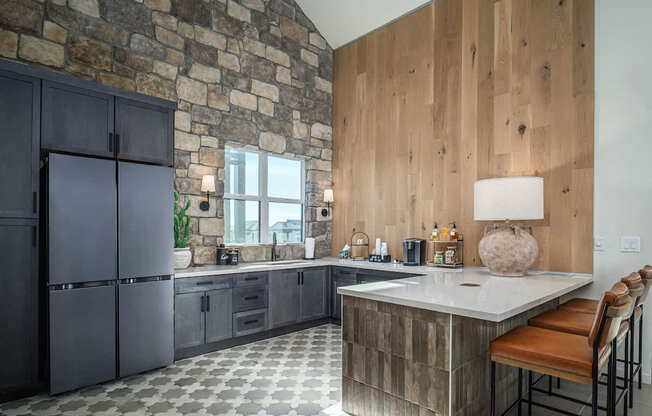 A kitchen with a stone wall and wooden paneling.