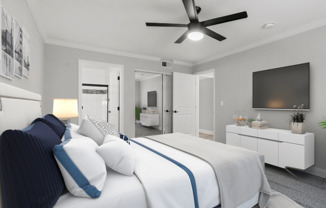 Carpeted bedroom with ceiling fan and private bathroom.