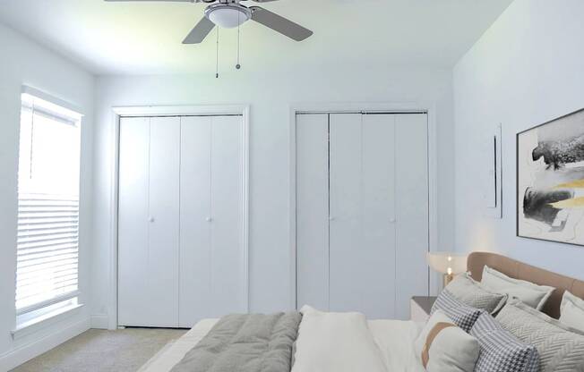 a bedroom with a bed and a ceiling fan