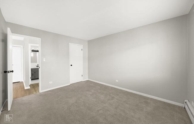 an empty living room with white walls and a carpet