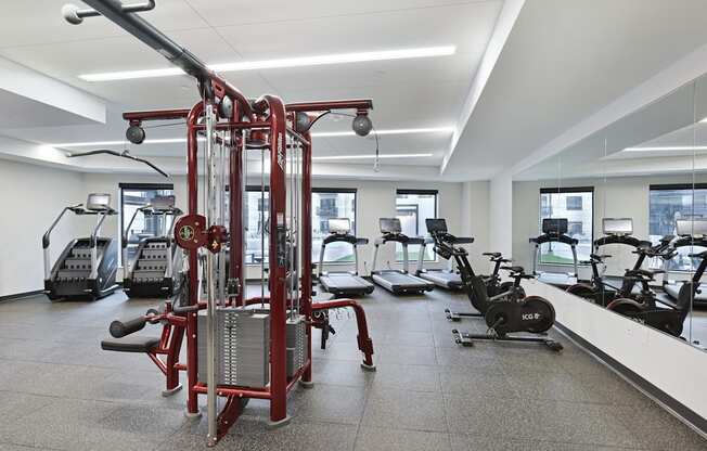 A gym with a variety of equipment including a leg press machine.