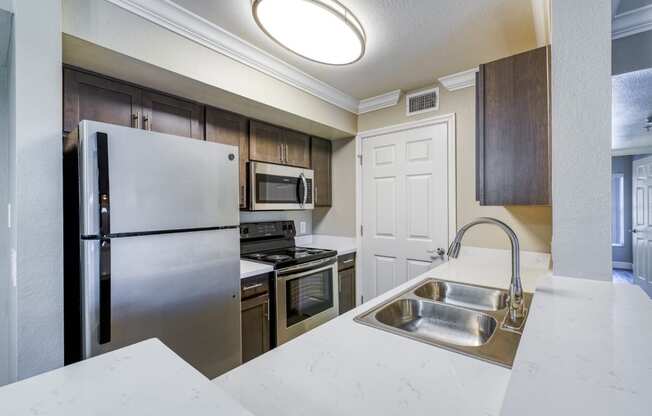 a kitchen with stainless steel appliances and a sink