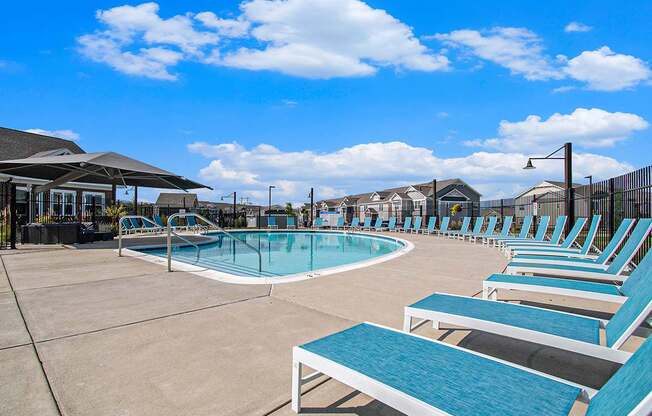 Swimming pool with lounge chairs at Strathmore Apartment Homes in West Des Moines, Iowa