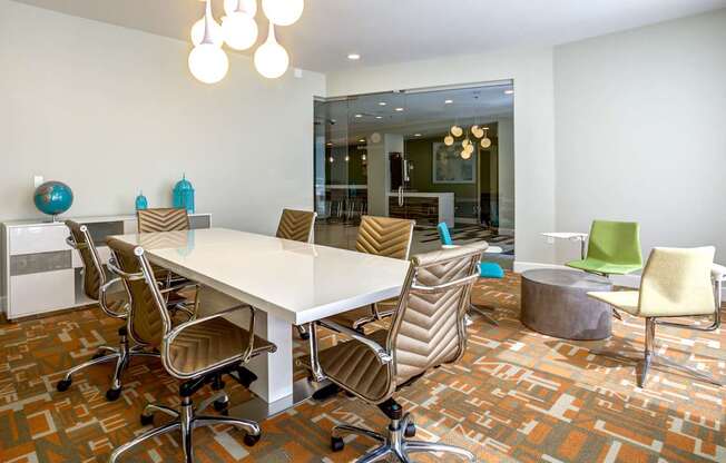 A conference room with a white table and chairs.
