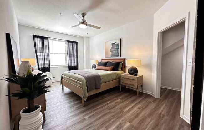 a bedroom with a bed and a ceiling fan