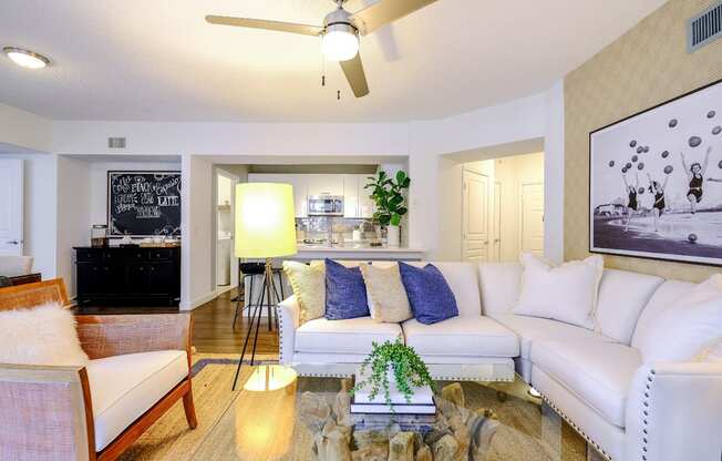 Spacious living area with hardwood-inspired floors and a ceiling fan at Sophia at Abacoa luxury Jupiter, FL apartments for rent