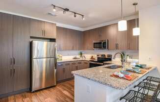 Kitchen with stainless steel appliances at The Exchange Luxury Apartments in St. Petersburg, FL