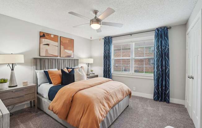 Cozy bedroom with plush carpeting and large windows at Reserve at Drakes Creek