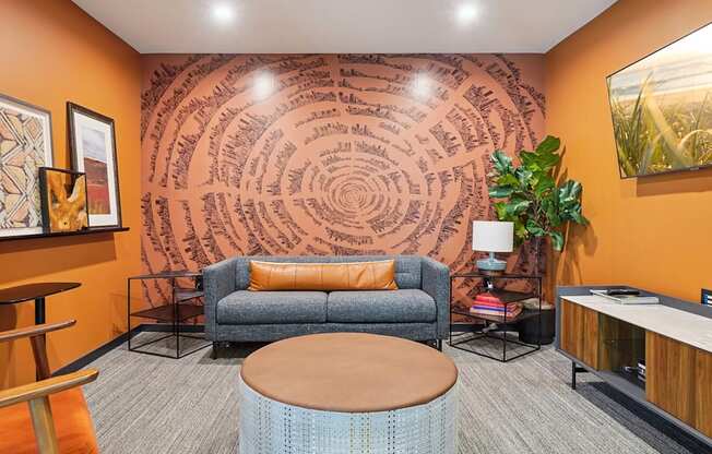 A living room with a couch, a chair, a table, and a plant.
