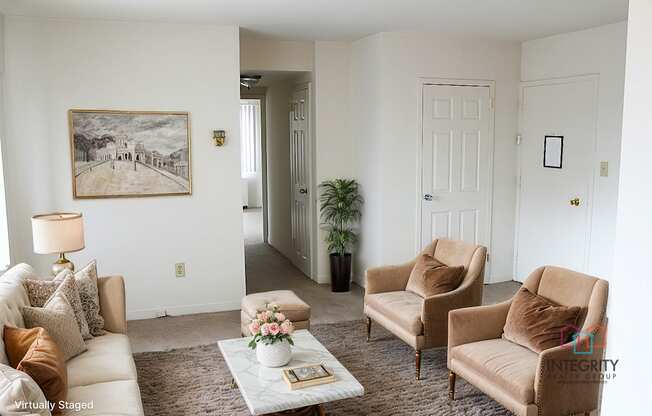 A living room with a white couch, two chairs, and a coffee table Integrity Realty, 44120