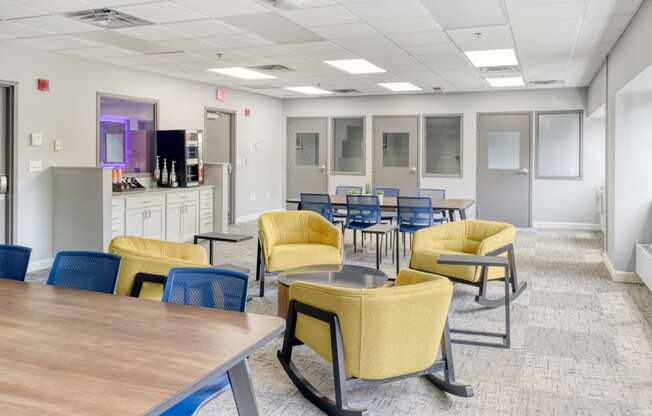 a common area with tables and chairs and a television