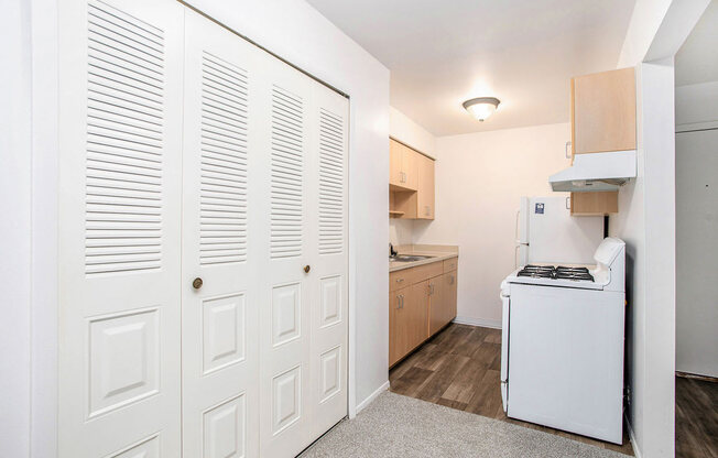 a kitchen with a large closet at Fairlane Apartments in Springfield, MI