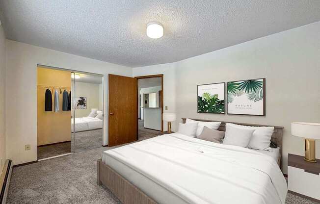 a bedroom with a large bed and a closet
