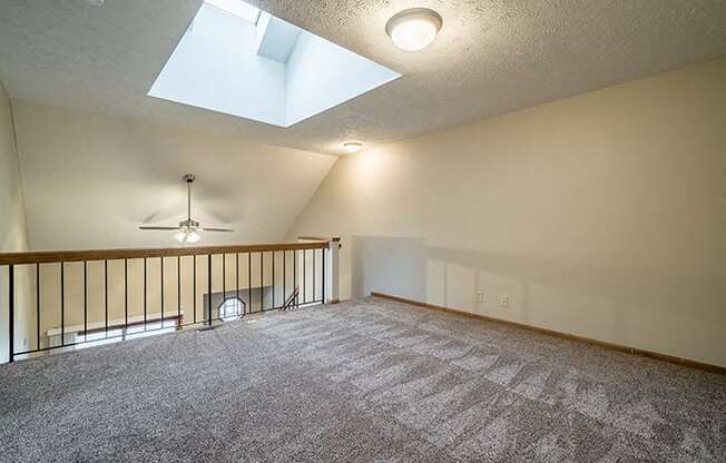 View of the loft with a skylight in a Fountain Glen Apartment