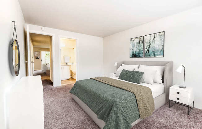 A bedroom with a bed, nightstand, and a painting on the wall.