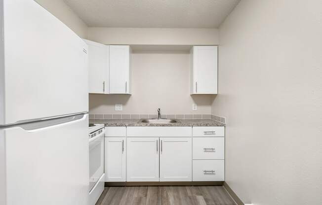 a kitchen with white cabinets and white appliances at Wildflower, Kennewick