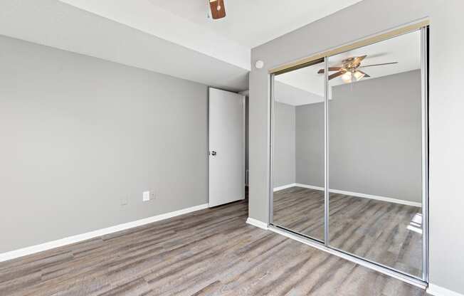 Bedroom with large closet mirror door at Eddingham in Lawrence, KS