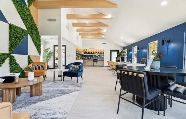 A modern living room with a green plant wall and blue accent wall.