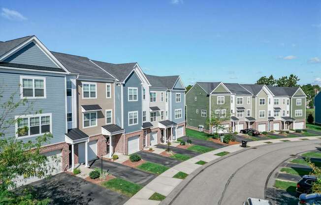 A row of houses with a car parked in front of them.