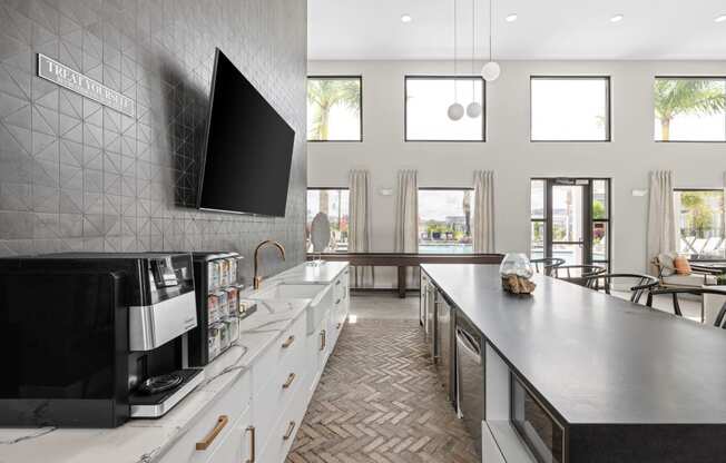 a large kitchen with a large counter and a tv on the wall at The Sophia, Venice, FL, 34275