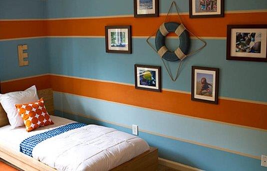 a bedroom with a bed and pictures on the wall