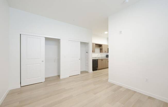 Large room with wood floors and closet 