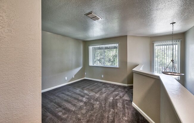 an empty living room with a large window