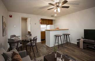 A living room with a grey couch and a brown coffee table.