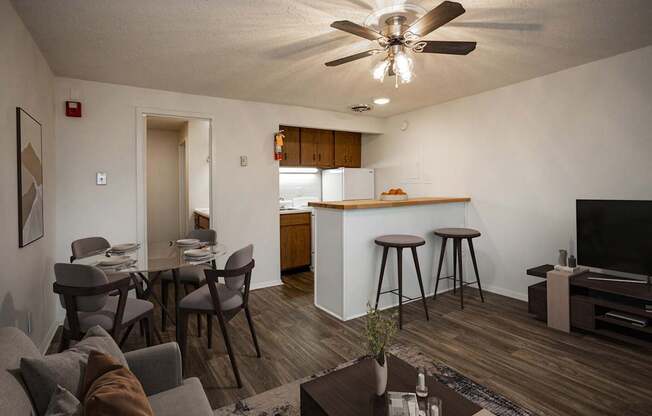 A living room with a grey couch and a brown coffee table.