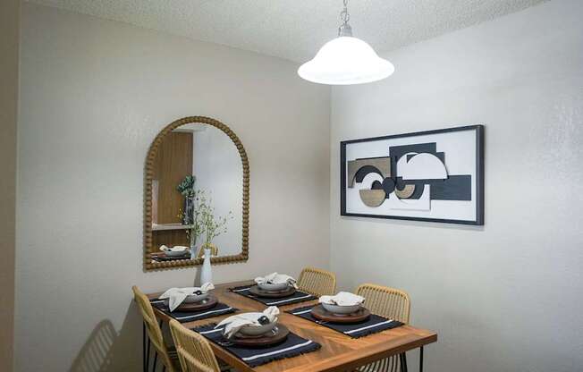 A dining table set with plates and napkins is ready for a meal.