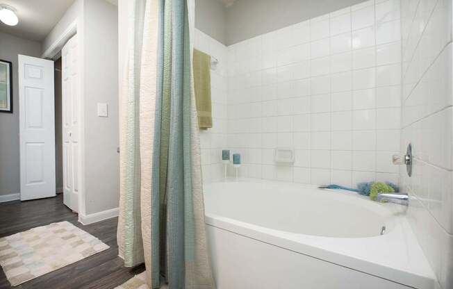 a white bathroom with a tub and a shower