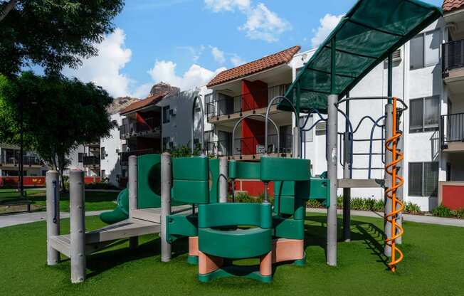 a playground with a building in the background