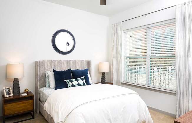 a bedroom with a large bed and a window