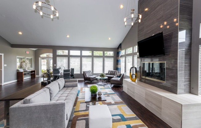 a large living room with a large fireplace and a large tv on the wall at Misty Ridge Apartments, Woodbridge Virginia