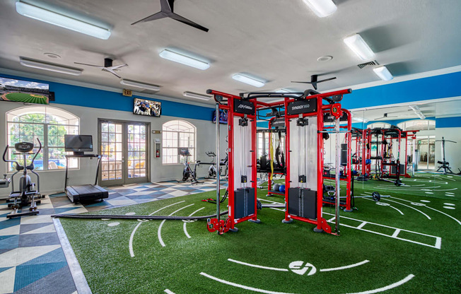 a gym with weights and equipment on a fake football field
