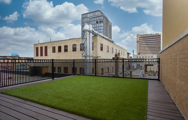a small astroturf lawn on the roof of a building