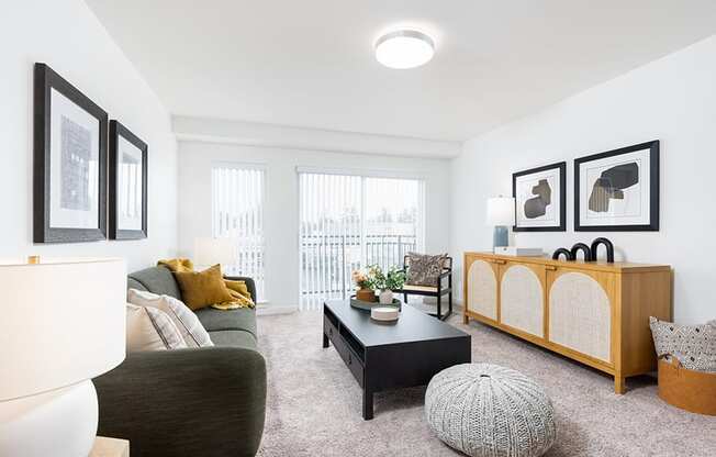 a living room with a grey couch and a black coffee table at QUINN BY VINTAGE, Shoreline, WA