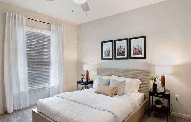 a white bedroom with a large bed and a window at Volare at the Woodlands, The Woodlands, 77384